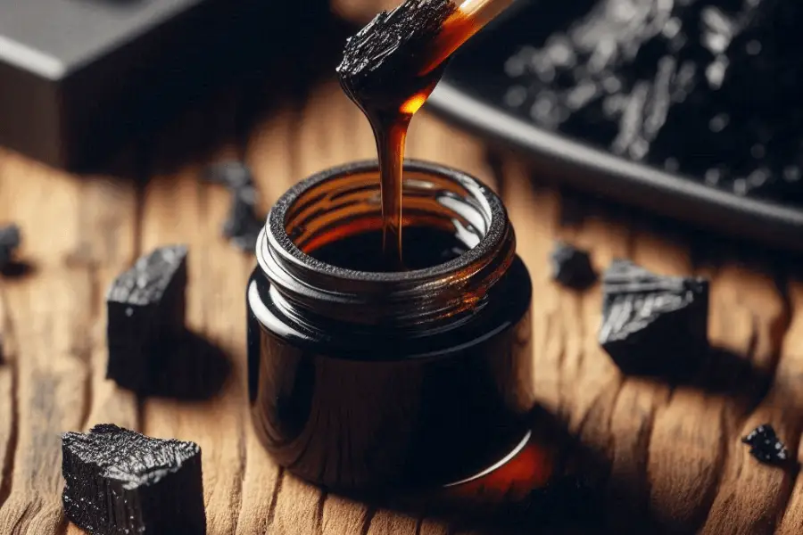 shilajit resin dripping into a jar